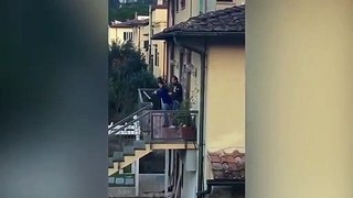 Neighbours play instruments from Balconies as Italy stays under Lockdown Due To Corona Virus Disaster.