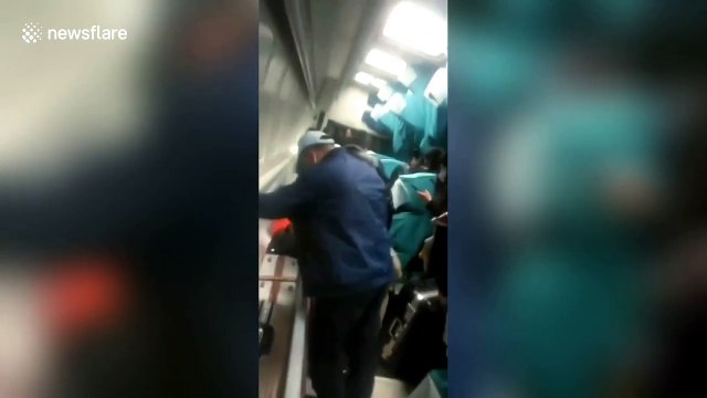 Passengers trapped in derailed train try to climb out of windows to escape in China