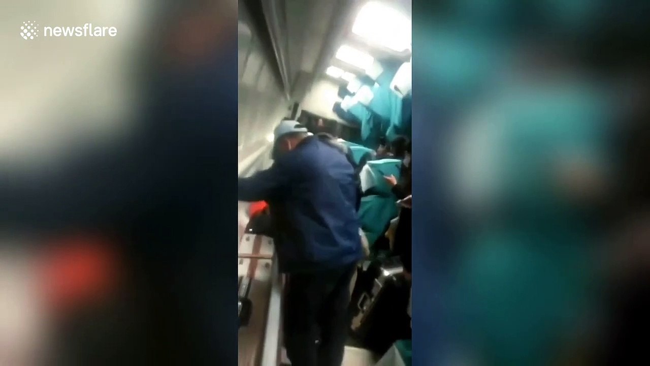 Passengers trapped in derailed train try to climb out of windows to escape in China