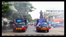 Government officers hose disinfectant onto streets in Indonesia