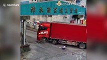 Scooter driver narrowly escapes being run over by truck turning corner in China