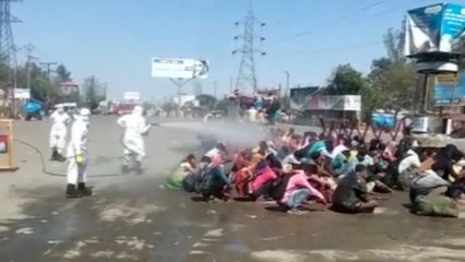 Outrage as migrant workers in India sprayed with disinfectant amid coronavirus pandemic