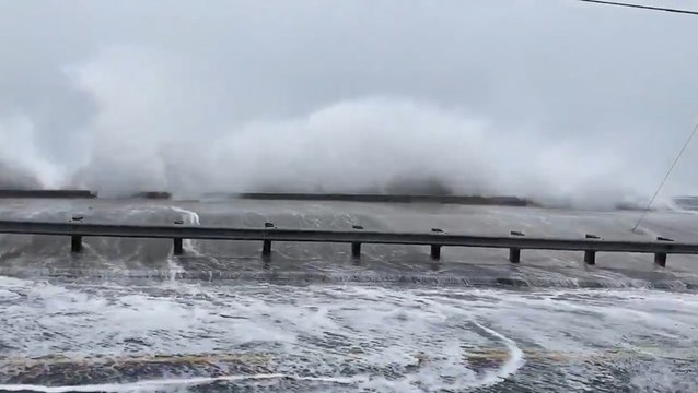 Coastal flooding spills inland as waves slam ashore