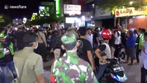Police in Indonesia city disperse crowds gathering in cafes during COVID-19 pandemic