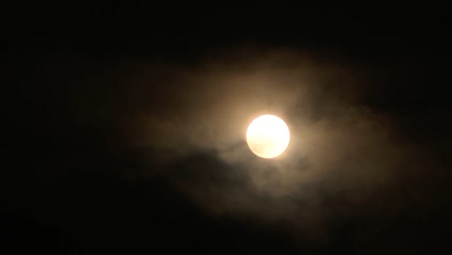 Supermoon peaks through storm clouds