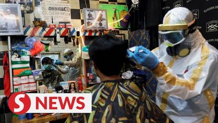 "Please don't judge": Indonesian barber gears up in handmade suit against virus outbreak
