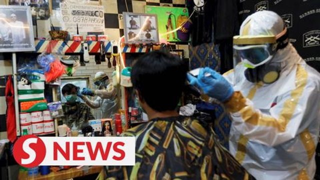 Please don't judge : Indonesian barber gears up in handmade suit against virus outbreak