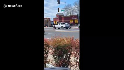 Two men hold up traffic as they fight on busy intersection in California
