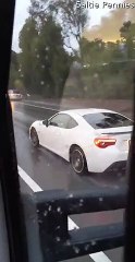 Woman Drives Along Watching a Movie