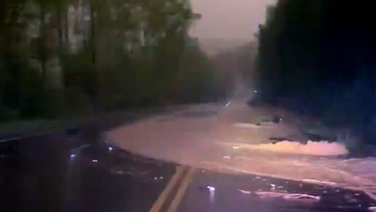 Flooding spills into this road in midst of heavy downpour