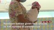Newborns given tiny face shields at a Bangkok hospital