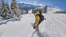 Guy Snowboards Through Trees on Snow Covered Mountains