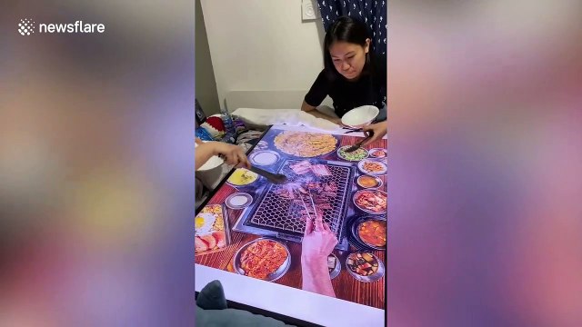 Canadian sisters put down TV screen to fake having Korean barbecue during COVID-19 lockdown