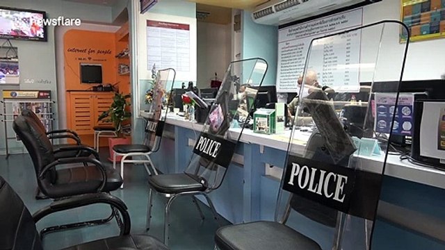 Thai police are using their riot shields as coronavirus barriers when talking to the public