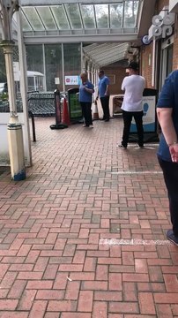 Supermarket worker's dance moves keep queuing shoppers entertained