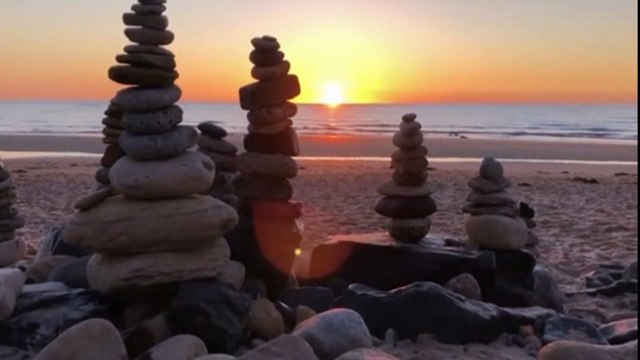 Stone-castles! Hundreds of pebble cairns are built on deserted Northumberland beach during lockdown