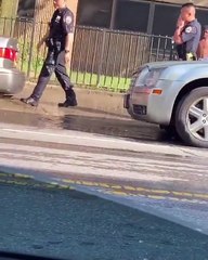 Police Walk Away After Getting Drenched