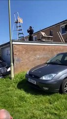 Kevin Wright performing an Elvis tribute act on his roof