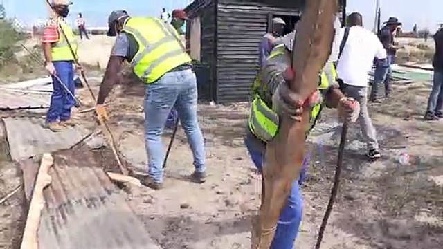 Cape Town residents clash with riot police over illegally erected shacks