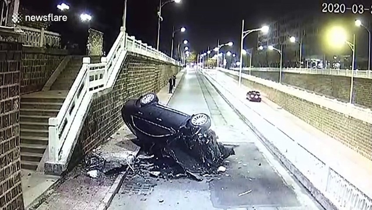 Car flies over overpass in China and smashes into wall after driver accidentally presses accelerator
