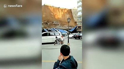 Garage collapses and vehicles buried after landslide hits Chinese residential community