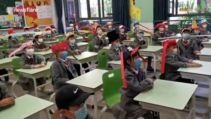 Chinese pupils wear one-metre-wide hats to keep safe distance with others