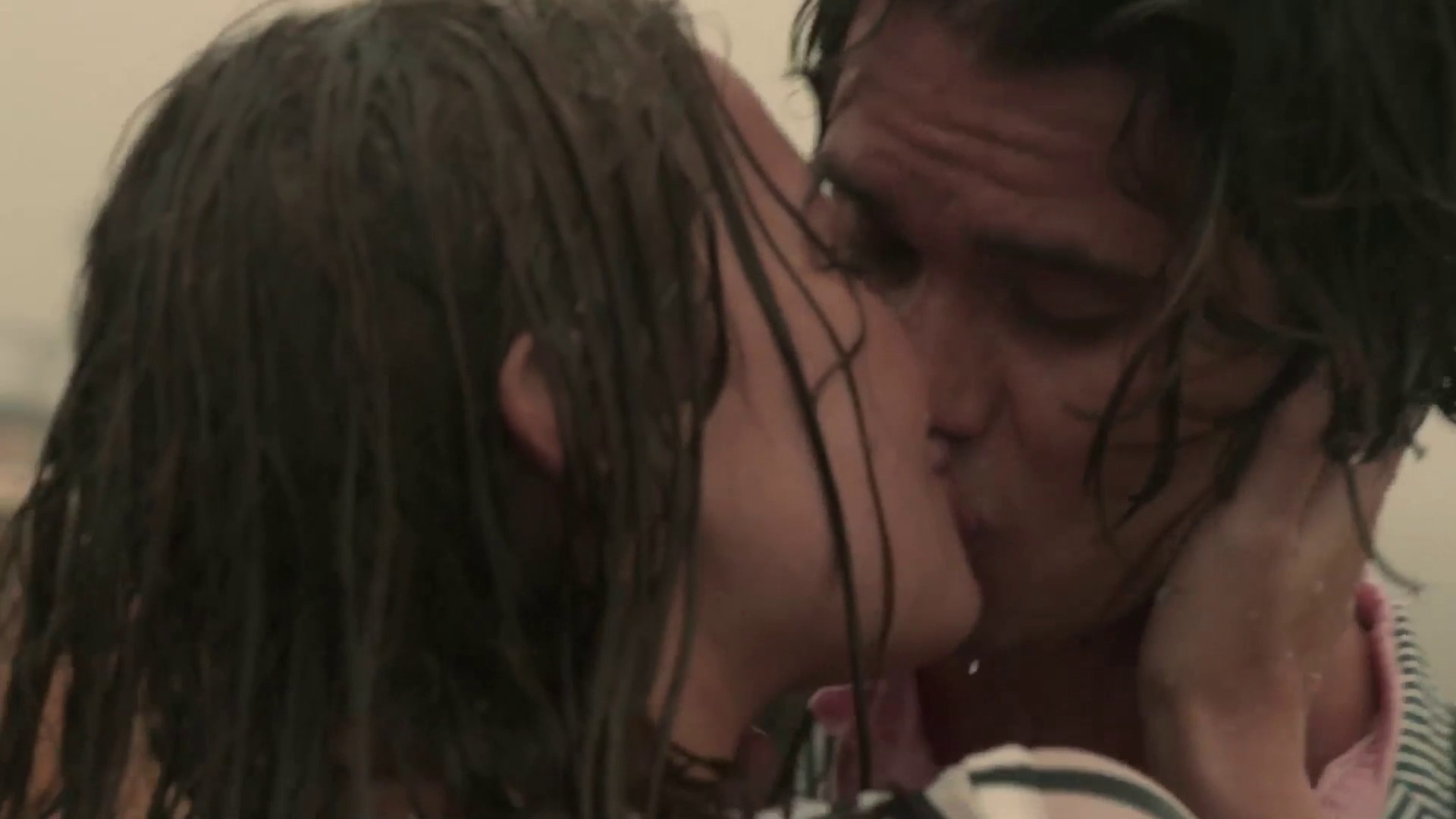 Madelyn Cline in a passionate embrace during a scene