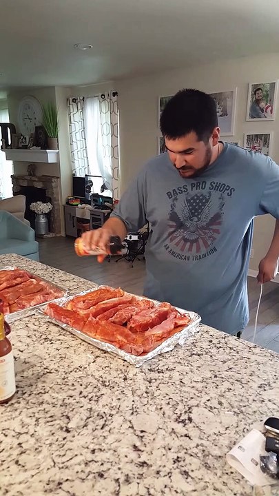 Dad Seasons Dinner While Entertaining Toddler