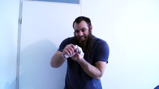 Tearing rolled up papers into 3 pieces by turning and bending it