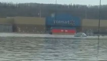 Cars trapped as floodwaters sweep through parking lot