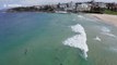 Surfers and swimmers hit the sand after Bondi Beach reopens in Sydney