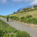 Guy Skateboarding Downhill Fails to Make a Turn and Falls