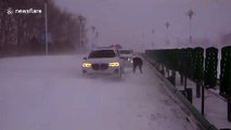 Chinese firefighters rescue people from cars that were trapped on snow-covered road due to powerful blizzard