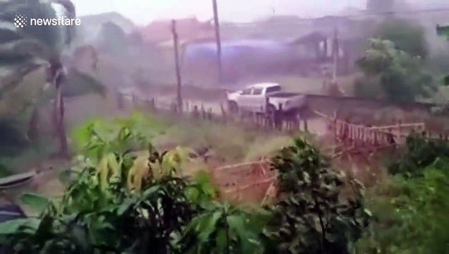 Tropical storm batters northern Thailand as residents shelter inside homes