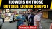 Man showers flower petals on people standing in queues outside liquor shops | Oneindia News