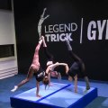 Three Girls Hold Each Other's Hands to do Single-Handed Handstand