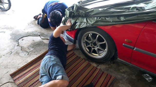 Puppy rescued after sheltering under car during thunderstorm in Thailand and getting stuck in wheel