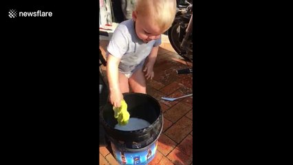 'Lazy' dad teaches two-year-old son how to clean motorbike so he doesn't have to