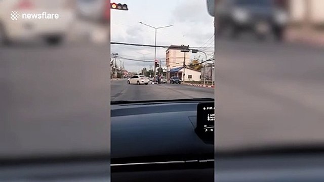 Food delivery rider stops traffic to help frail pensioner cross road in Thailand
