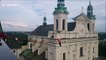 Watch this terrifying slackline surf between church towers in Poland
