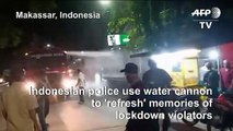 Indonesian authorities use water cannon to disperse lockdown violators