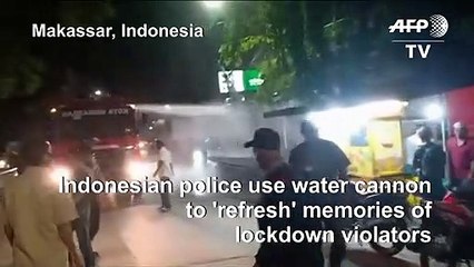 Indonesian authorities use water cannon to disperse lockdown violators