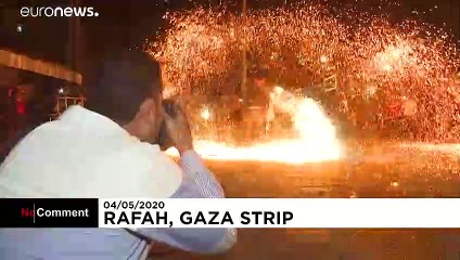 Palestinian youth swirl homemade sparkler firework for Ramadan