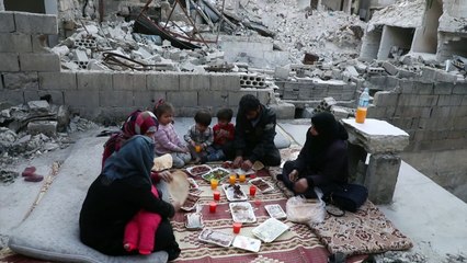 عائلة تتناول إفطار رمضان على أطلال منزلها في شمال غرب سوريا