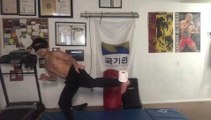 Blindfolded Guy Practices Martial Arts by Kicking Toilet Paper Roll