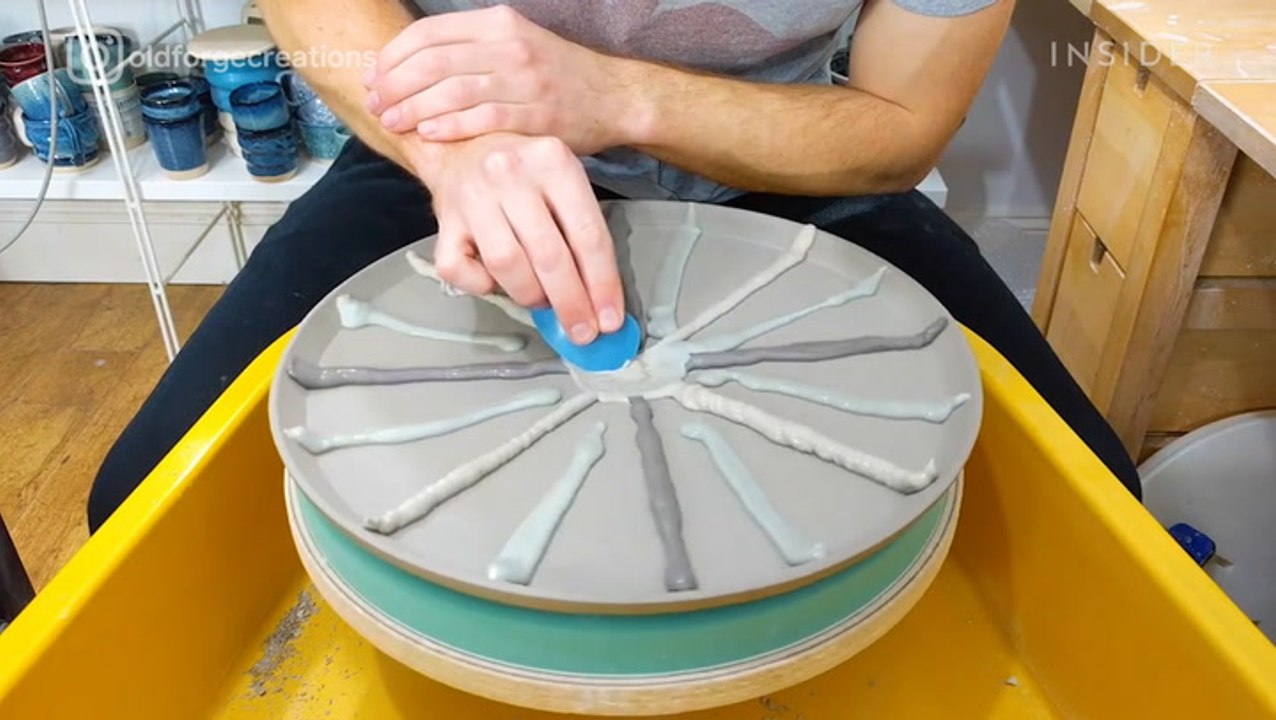 Artist indents clay to make textured pottery