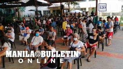 Residents of Bagong Silang Phase 3 wait in line at Sto. Niño Elementary School