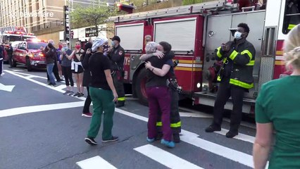 Emotional scenes as crying nurses hug female firefighter at NYU Langone medical center