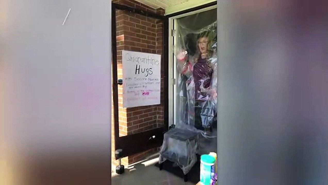 Second Grade Teacher Hugs Students Through Homemade Plastic Barrier