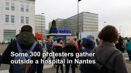 Hundreds protest outside French hospital over virus response